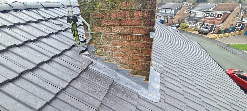 a lead welded back gutter installed on a chimney in Manchester